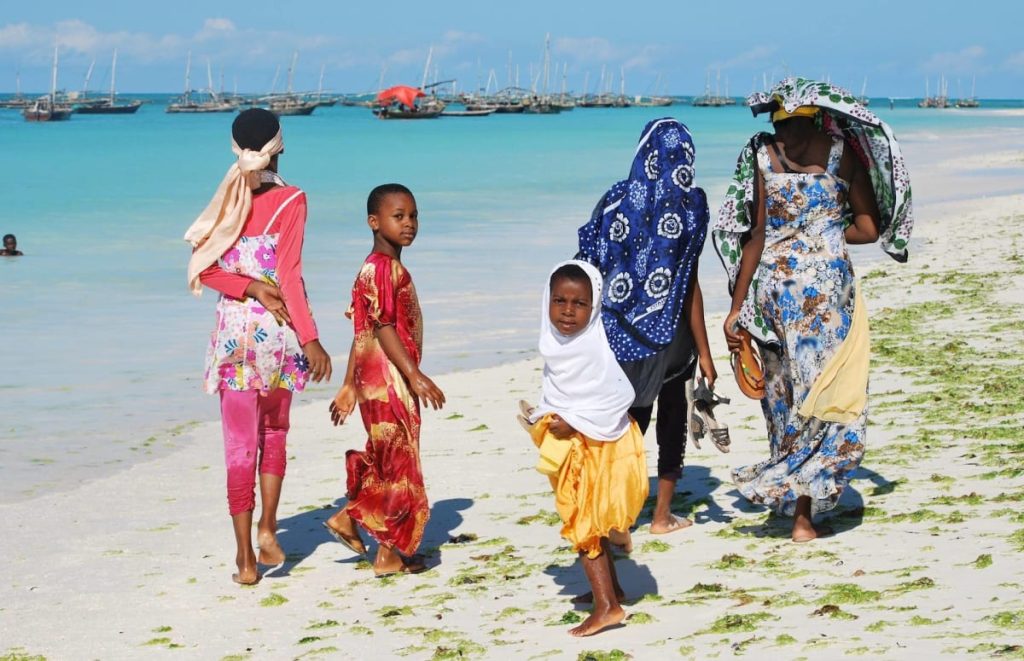 Kids walking along the beach in Zanzibar Tanzania Safarisoko